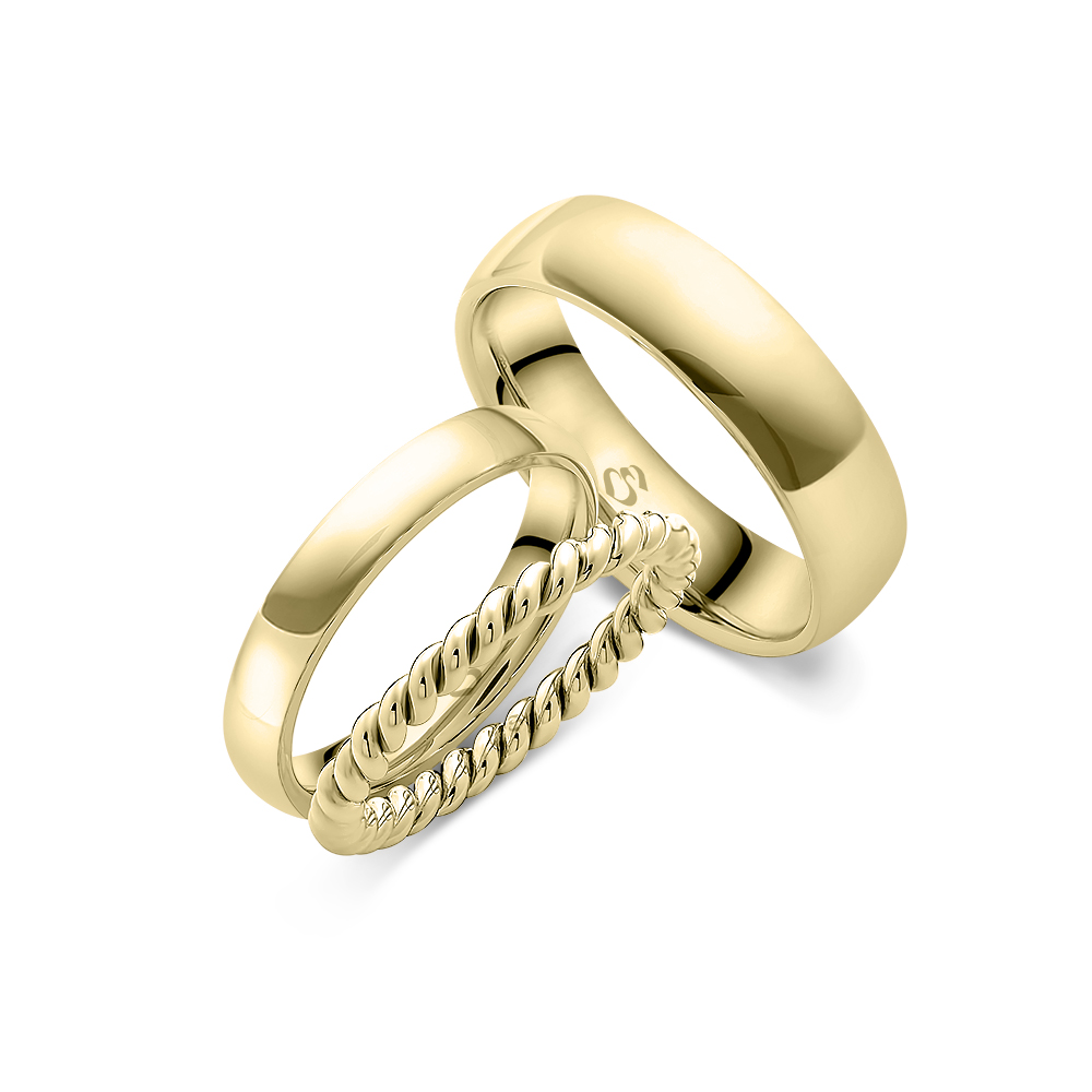 Drei goldene Ringe mit glatter und gedrehter Oberfläche, glänzend und modern